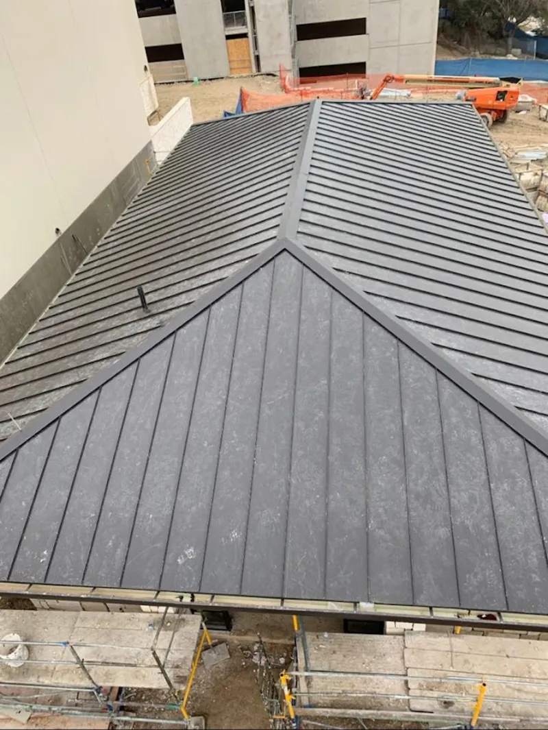 Commercial metal roof construction with crane equipment in Sugar Grove