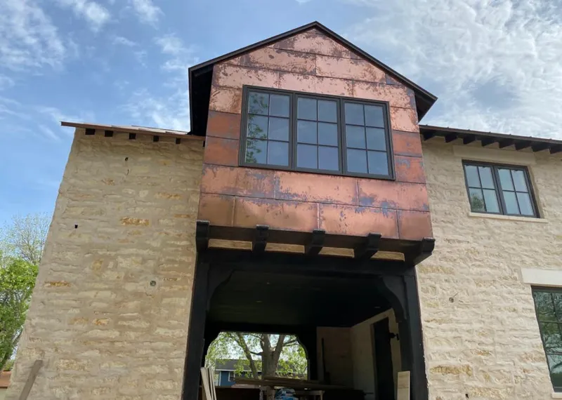 Copper metal panel facade on a stone building for Skylight Installation in Sugar Grove